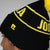 Close up image of the JOOLA winter beanie, black and yellow.