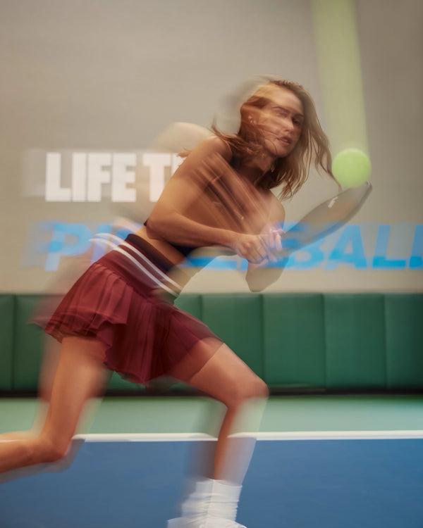 Blurry image of a pickleball play at an indoor court at Lifetime pickleball.