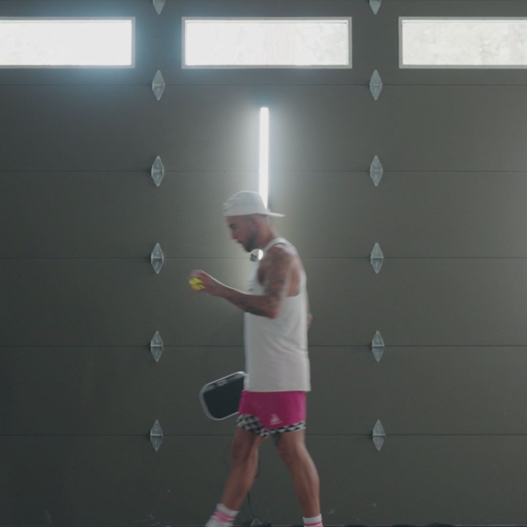 Video of Tyson McGuffin with paddle and ball in the garage.
