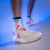 Close up of a stylized image of a pair of JOOLA TT SM4SH table tennis shoes with white and red. And wearing a pair of JOOLA athletic socks.