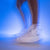 Close up of a stylized image of a pair of JOOLA TT SM4SH table tennis shoes with white and gray.