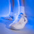 Close up of a stylized image of a pair of JOOLA TT SM4SH table tennis shoes with white and blue.